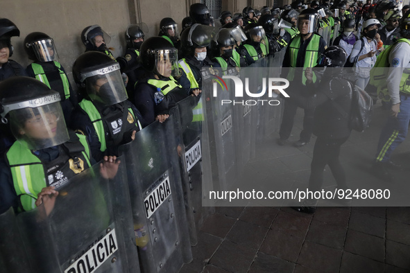 Police guard the Zocalo in Mexico City during the march of mothers of victims of femicides, relatives of disappeared persons and various fem...