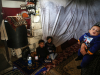 A Palestinian family stand at their house in Nahr al-Bared camp in Khan Yunis in the southern Gaza Strip on November 28, 2022.
 (