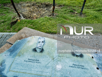 Glass remains of an army memorial in Nikopol near a russian rocket impact hole. The glass panels of the memorial with photos of killed ukrai...
