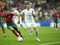 Darwin Nuñez Centre-Forward of Uruguay and Liverpool FC and Ruben Neves defensive midfield of Portugal and Wolverhampton Wanderers compete f...