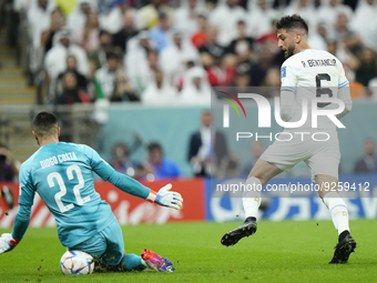 Rodrigo Bentancur Central Midfield of Uruguay and Tottenham Hotspur shooting to goal and Diogo Costa goalkeeper of Portugal and FC Porto mak...
