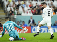 Rodrigo Bentancur Central Midfield of Uruguay and Tottenham Hotspur shooting to goal and Diogo Costa goalkeeper of Portugal and FC Porto mak...