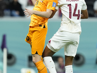 Davy Klaassen attacking midfield of Netherlands and Ajax Amsterdam and Homam Ahmed left-back of Qatar and Al-Gharafa SC compete for the ball...