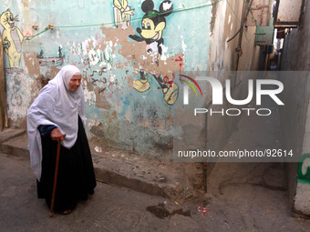 A Palestinian woman walks in the Shati refugee camp west of Gaza City, on April 27, 2014. (