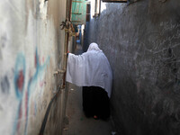 A Palestinian woman walks in the Shati refugee camp west of Gaza City, on April 27, 2014. (