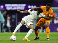 Akram Afif left winger of Qatar and Al-Sadd SC and Jurrien Timber centre-back of Netherlands and Ajax Amsterdam compete for the ball during...
