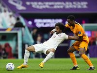 Akram Afif left winger of Qatar and Al-Sadd SC and Jurrien Timber centre-back of Netherlands and Ajax Amsterdam compete for the ball during...