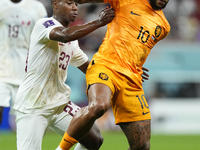 Memphis Depay centre-forward of Netherlands and FC Barcelona and Assim Madibo defensive midfield of Qatar and Al-Duhail SC  acoo during the...