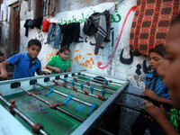 Palestinian children play at table football outside their house in the Shati refugee camp west of Gaza City, on April 27, 2014. (