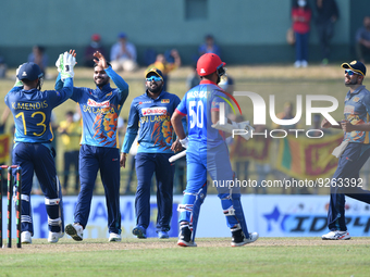 Sri Lankan players celebrate with their teammates after taking the wicket of Afghanistan during the final one-day international cricket matc...