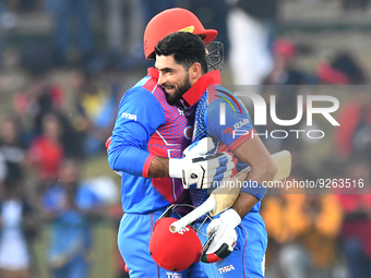 Afghanistan's  Ibrahim Zadran celebrates with his teammate after scoring a century during the final one-day international cricket match betw...