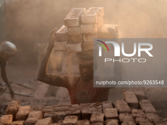 Seasonal Migrant workers during work at a brick-making field in Dhaka, Bangladesh on November 30, 2022. (