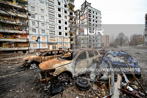 ZAPORIZHZHIA, UKRAINE - NOVEMBER 22, 2022 - Crashed cars are left outside an apartment building destroyed in the shelling of Russian troops,...