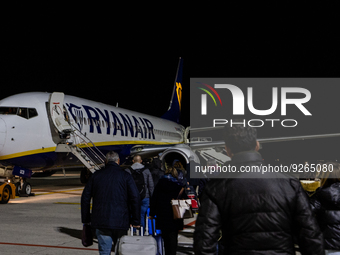 People board a Ryanair Boeing 737-800 airplane at Treviso A. Canova International Airport (TSF) in Treviso, Italy, on November 27, 2022. (