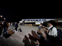 People deplane from a Ryanair airplane at Salento Airport, in Brindisi, Italy, on November 27, 2022. (
