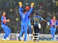 Afghanistan's Mohammad Nabi celebrates with their teammates after taking the wicket of Sri Lanka during final one-day international cricket...