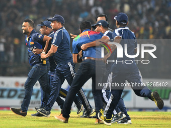 A  Sri Lankan Cricket fan runs into the ground and security officials attempt to stop him, Sri Lanka wins the final one-day international cr...