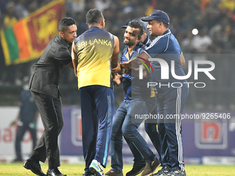 A  Sri Lankan Cricket fan runs into the ground and security officials attempt to stop him, Sri Lanka wins the final one-day international cr...