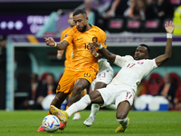 Memphis Depay centre-forward of Netherlands and FC Barcelona and Ismaeel Mohammed right winger of Qatar and Al-Duhail SC compete for the bal...