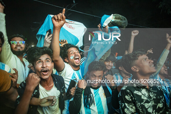 Football fans celebrate after Argentina players scored a goal as they watch the Qatar 2022 World Cup Group C football match between Argentin...