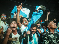 Football fans celebrate after Argentina players scored a goal as they watch the Qatar 2022 World Cup Group C football match between Argentin...