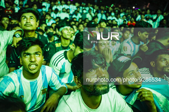 People watching a Qatar 2022 World Cup Group C football match between Argentina and Poland on a big screen, the Dhaka University area, on De...