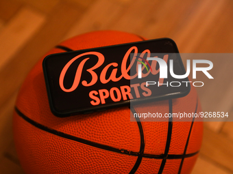 Bally Sports logo displayed on a phone screen and a basketball are seen in this illustration photo taken in Krakow, Poland on December 1, 20...
