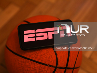 ESPN logo displayed on a phone screen and a basketball are seen in this illustration photo taken in Krakow, Poland on December 1, 2022. (