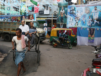 

A hand-pulled rickshaw is passing a large poster of Argentine football player Lionel Messi, celebrating the Qatar World Cup 2022, in Kolka...