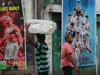 

A large poster of Argentine footballer Lionel Messi (right) and Portuguese footballer Cristiano Ronaldo (left) is being displayed to celeb...