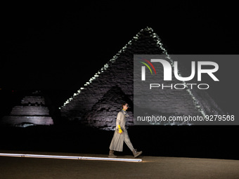 CAIRO, EGYPT- DECEMBER 3: A model walks the runway during the Dior Fall 2023 Menswear show on December 3, 2022 at the Giza Pyramids in Cairo...
