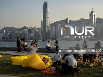 People at the West Kowloon Cultural District in front of the Hong Kong Skyline on December 9, 2022 in Hong Kong, China. (