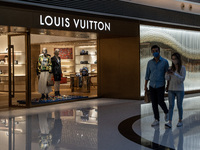 People walk pass a Louis Vuitton Store inside a Shopping mall on December 9, 2022 in Hong Kong, China. (
