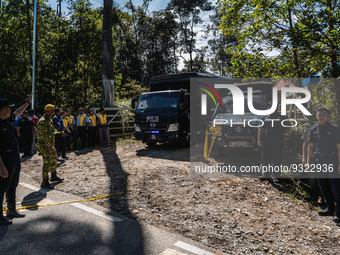 Vehicle carrying victim's bodies departs the site after a landslide hit the campsite in Batang Kali, state of Selangor, Malaysia, on Decembe...