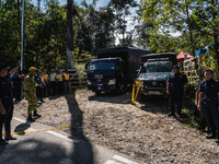 Vehicle carrying victim's bodies departs the site after a landslide hit the campsite in Batang Kali, state of Selangor, Malaysia, on Decembe...