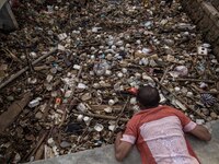 Indonesian environmental activist, Suparno Jumar takes a picture of plastic pollution at the river in Bogor, West Java, Indonesia, on Wednes...