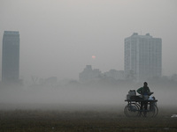 A snacks vendor sets up his stall on a field amidst morning smog, in Kolkata on December 18, 2022. 
 (