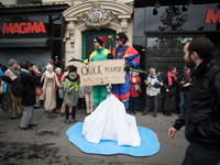 Two men demonstrate what is happening to the polar ice in front of people forming a human chain from Place de la République to Nation to dem...