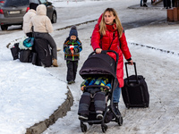 A family arrive at the railway station in Przemysl, Poland from Ukraine on December 20, 2022. Since the beginning of the Russian invasion on...