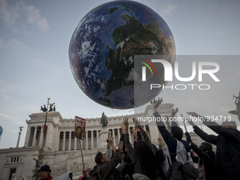 People play with a giant balloon representing Earth at Piazza Venezia during a rally calling for action on climate change on November 29, 20...