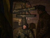 An ukrainian soldier talks with his fellows in  his underground base after returning from the frontlines in Zaporizhia region. (