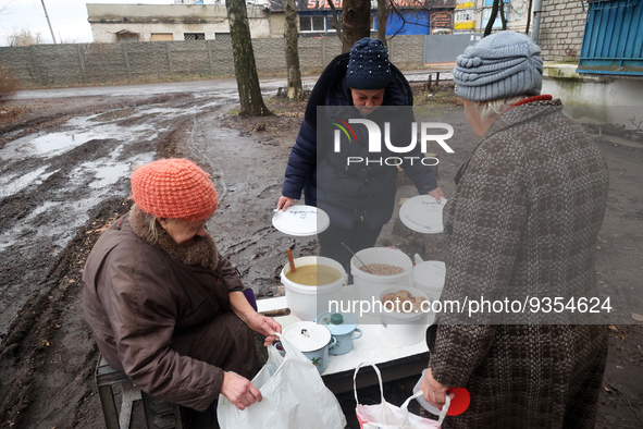 KHARKIV REGION, UKRAINE - DECEMBER 22, 2022 - Residents of the city of Izium liberated from the Russian occupiers receive hot food from volu...