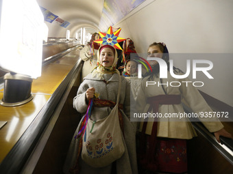 Ukrainian kids wearing national ethnic clothes sing Christmas carols and collect money at a metro station in Kyiv, Ukraine 25 December 2022....