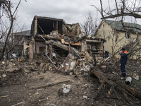 Local residents are removing the remnants of the residential house destroyed during massive Russian missile strike today early morning in Ky...