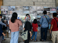 Tourists observe a photos of the 2010 eruption of Mount Merapi which were exhibited at the Citizen Museum during holiday for the end of the...