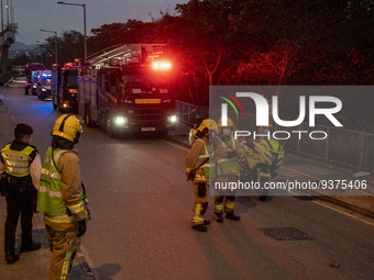 Firefighters and fire trucks near the site of a rolled over double decker bus on January 1, 2023 in Hong Kong, China. Police say 13 passenge...