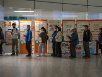 People lining up next to signs for the Sinovac CoronaVac Inactivated Vaccine by China Biotechnology company, Sinovac Biotech Ltd.,at a Covid...