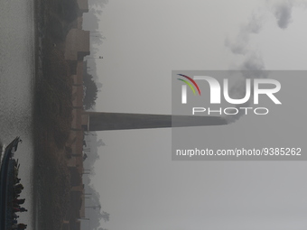 Smoke rises from a kiln of a brick field in Munshiganj, Bangladesh on January 3, 2023.  (