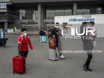 Travelers from China wearing face mask with luggages arrived in Shenzhen Bay Port on January 4, 2023 in Hong Kong, China. According to Local...