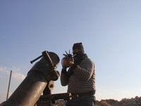 Free Syrian Army fighters prepare mortar shells towards the Sheikh Maqsud neighbourhood of the northern Syrian city of Aleppo on December 2,...
